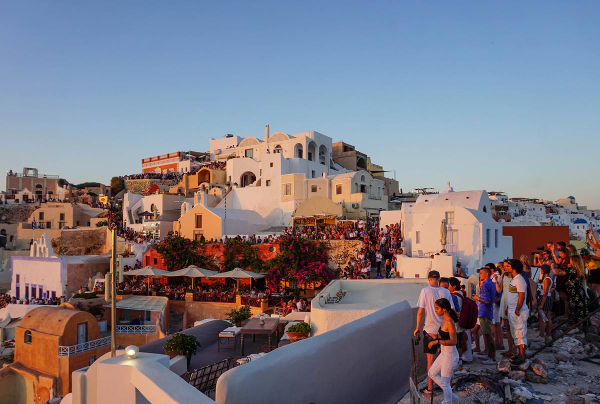 people gathered to see the sunset in Santorini